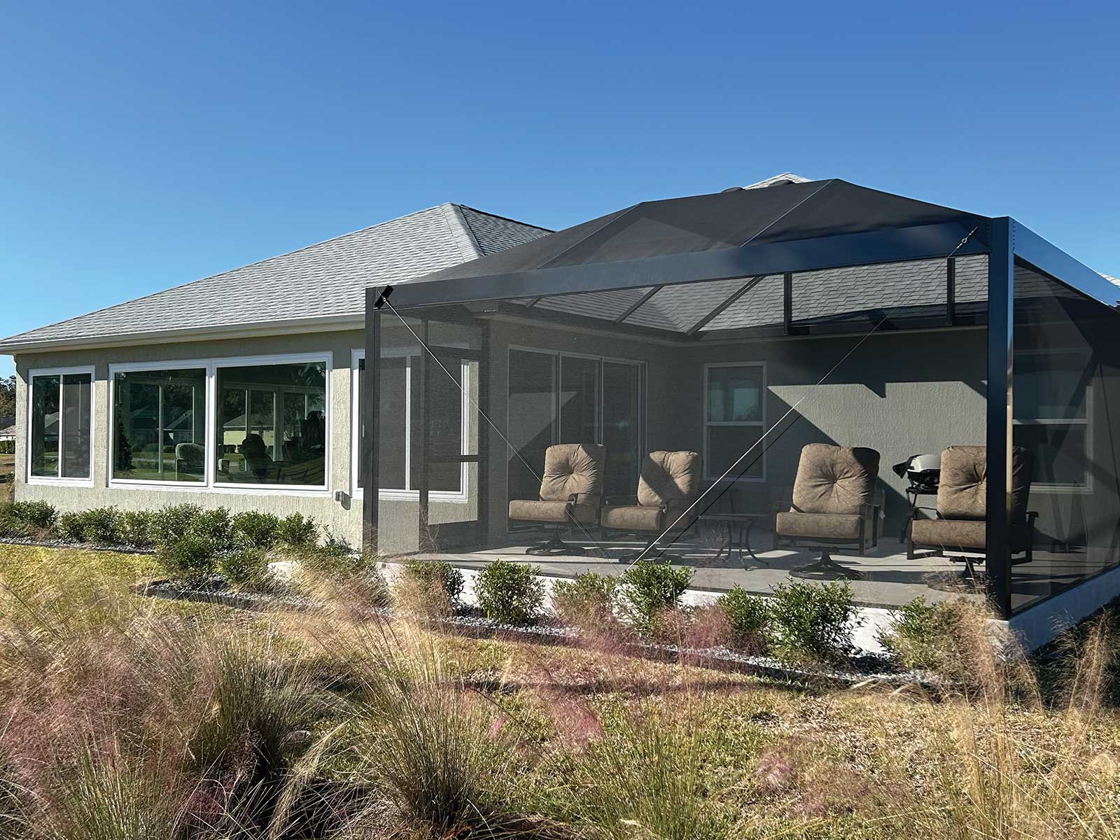 Room addition with a roofline-matched screened birdcage in The Villages, Florida by DNJ Construction