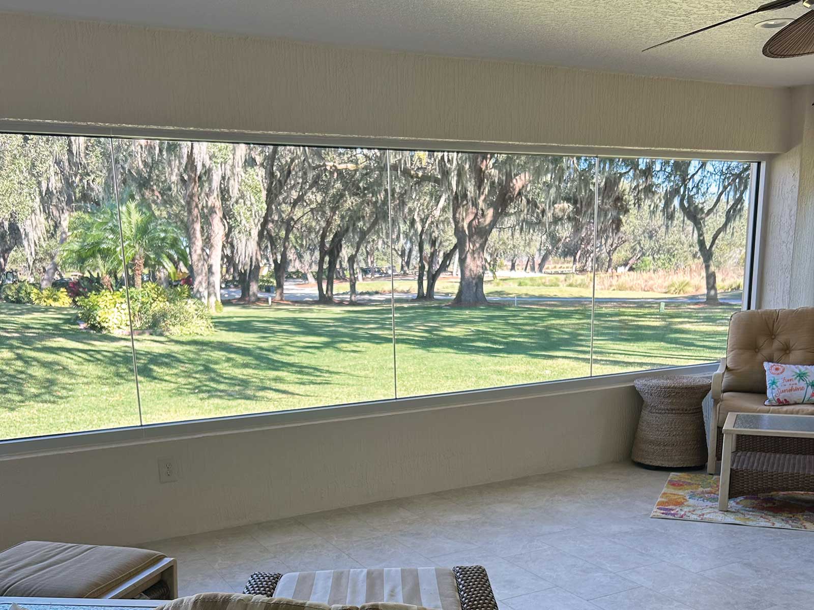 Insulated glass lanai enclosure with a wooded view, DNJ Construction