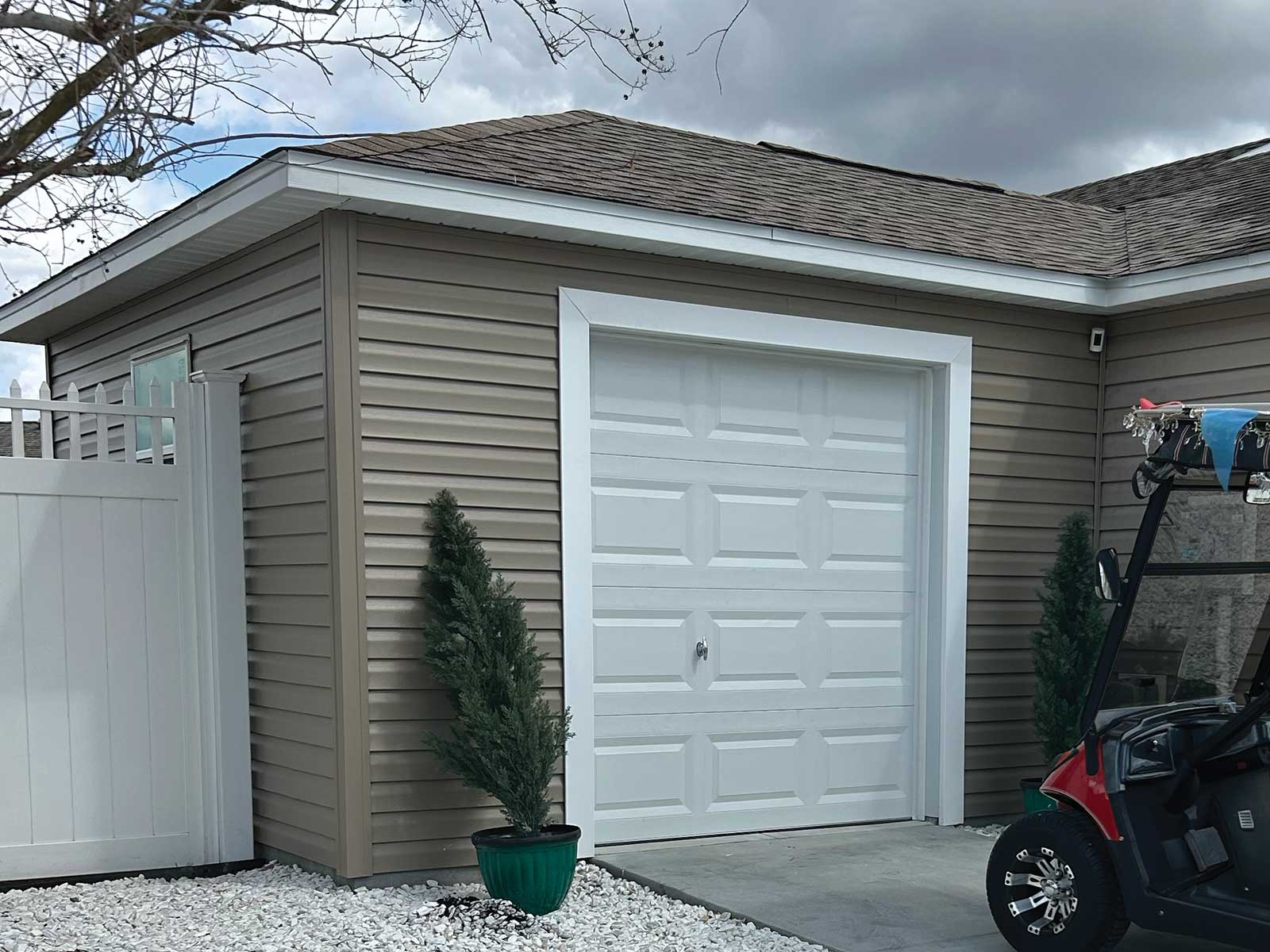 Golf cart garage addition matching existing siding and roofline in The Villages, Florida by DNJ Construction