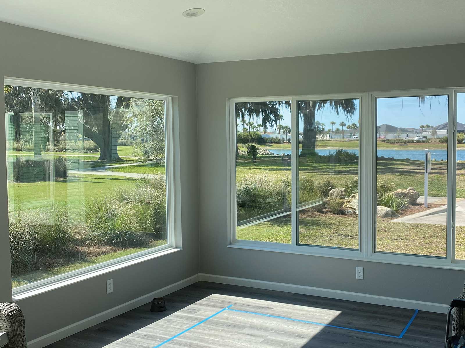 nsulated glass sunroom with corner windows overlooking a lake, DNJ Construction