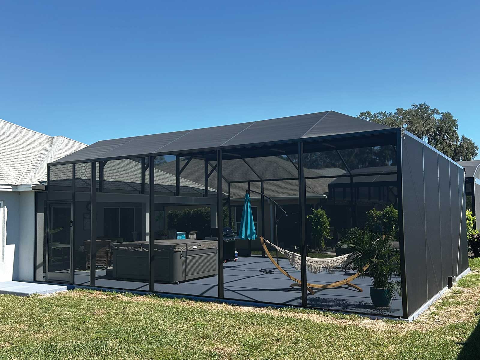 Screened birdcage enclosure with hot tub and hammock, DNJ Construction