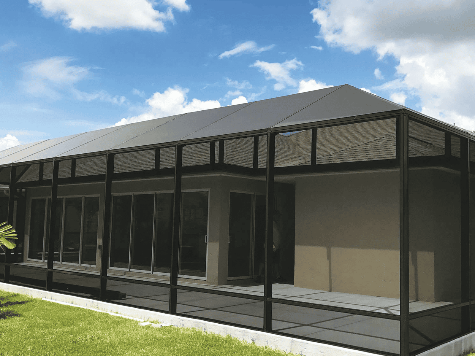 Screened patio addition with solid roof spanning the rear of the home, DNJ Construction