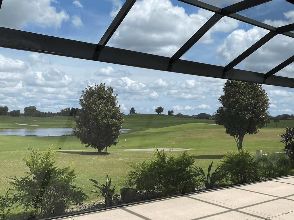 Screened birdcage enclosure overlooking a golf course and pond, DNJ Construction