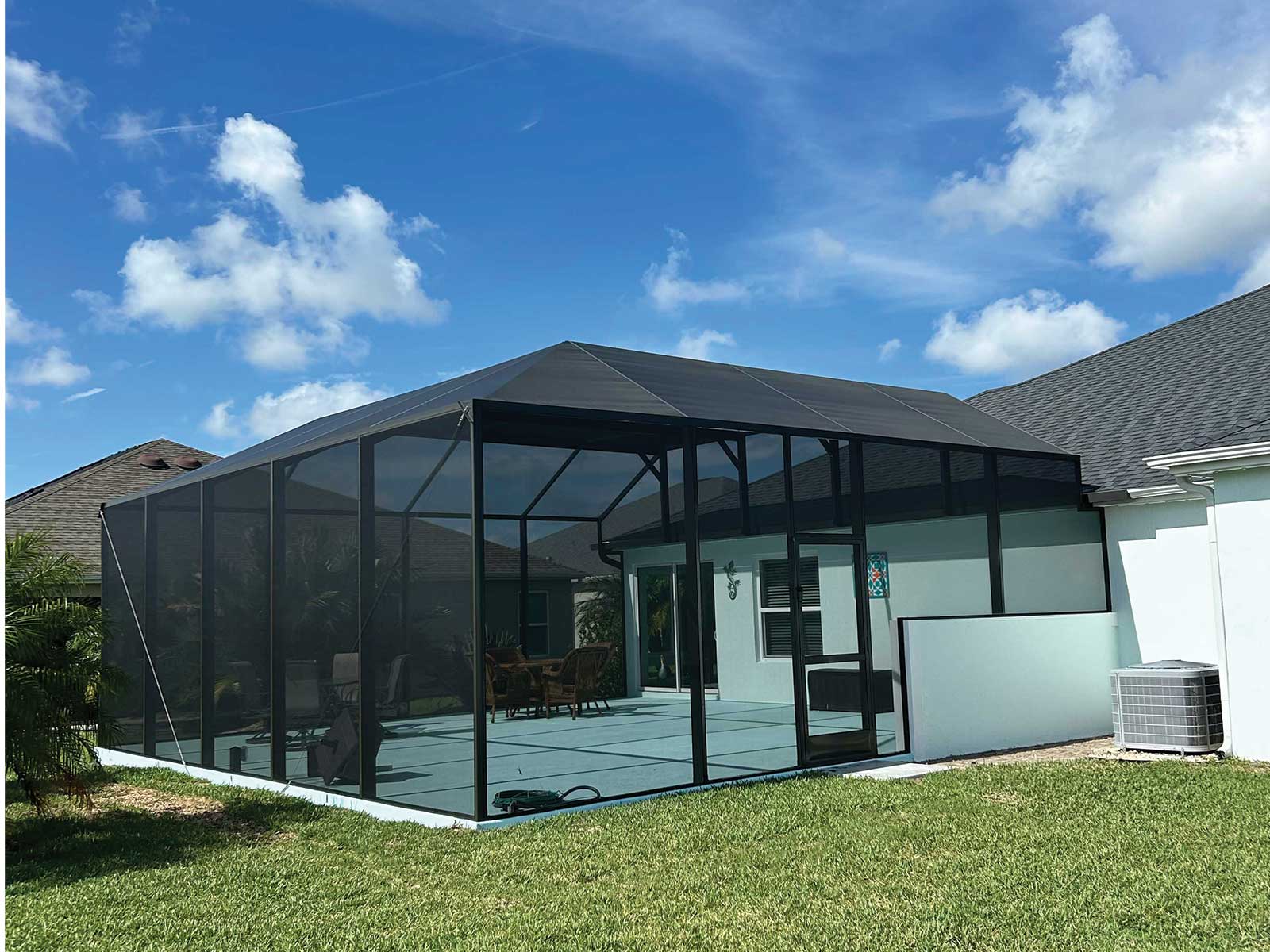 Screened birdcage with a gable roof over a paver patio, DNJ Construction